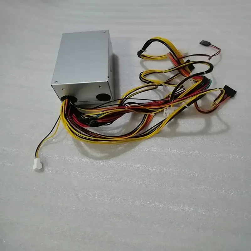 Small silver TFX power supply unit with fan grille and cable bundle