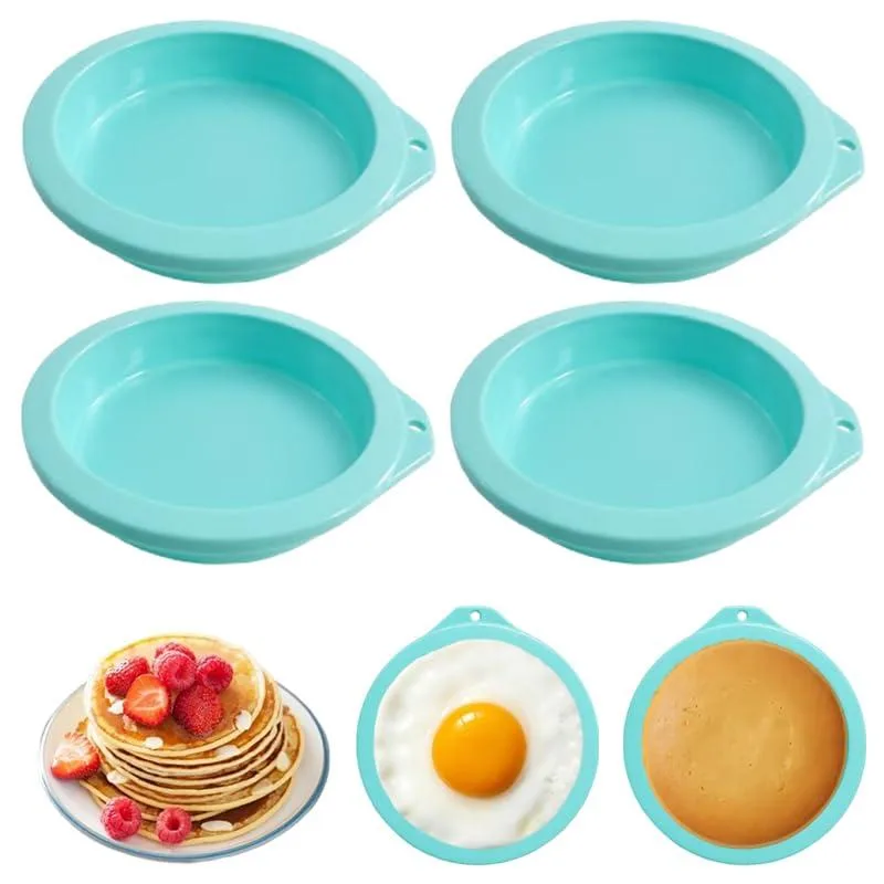 Four green silicone egg molds on a surface
