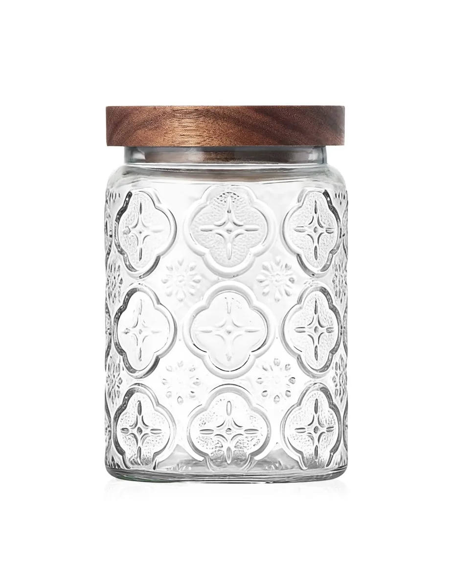 Clear glass jar with floral embossing and acacia wood lid, 3.74 inches wide by 5.51 inches tall