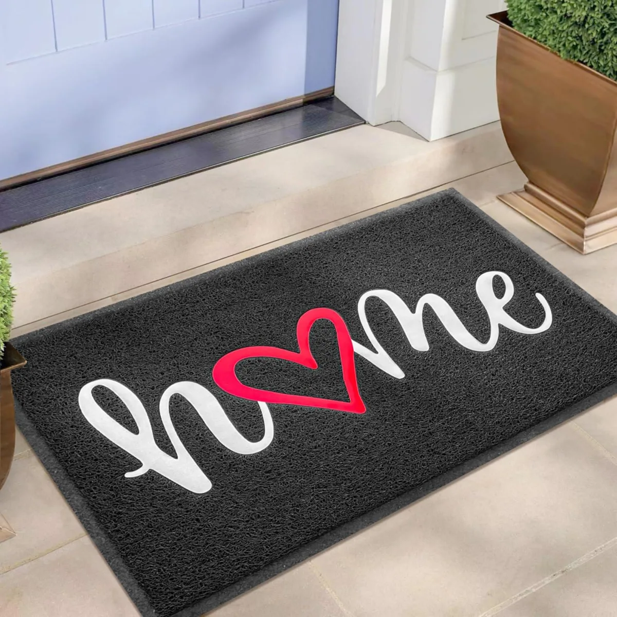 Rectangular black doormat with striped pattern and rubber backing, 30 by 17.5 inches