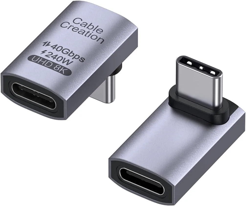Two white USB-C right-angle adapters with UP orientation, compact rectangular bodies