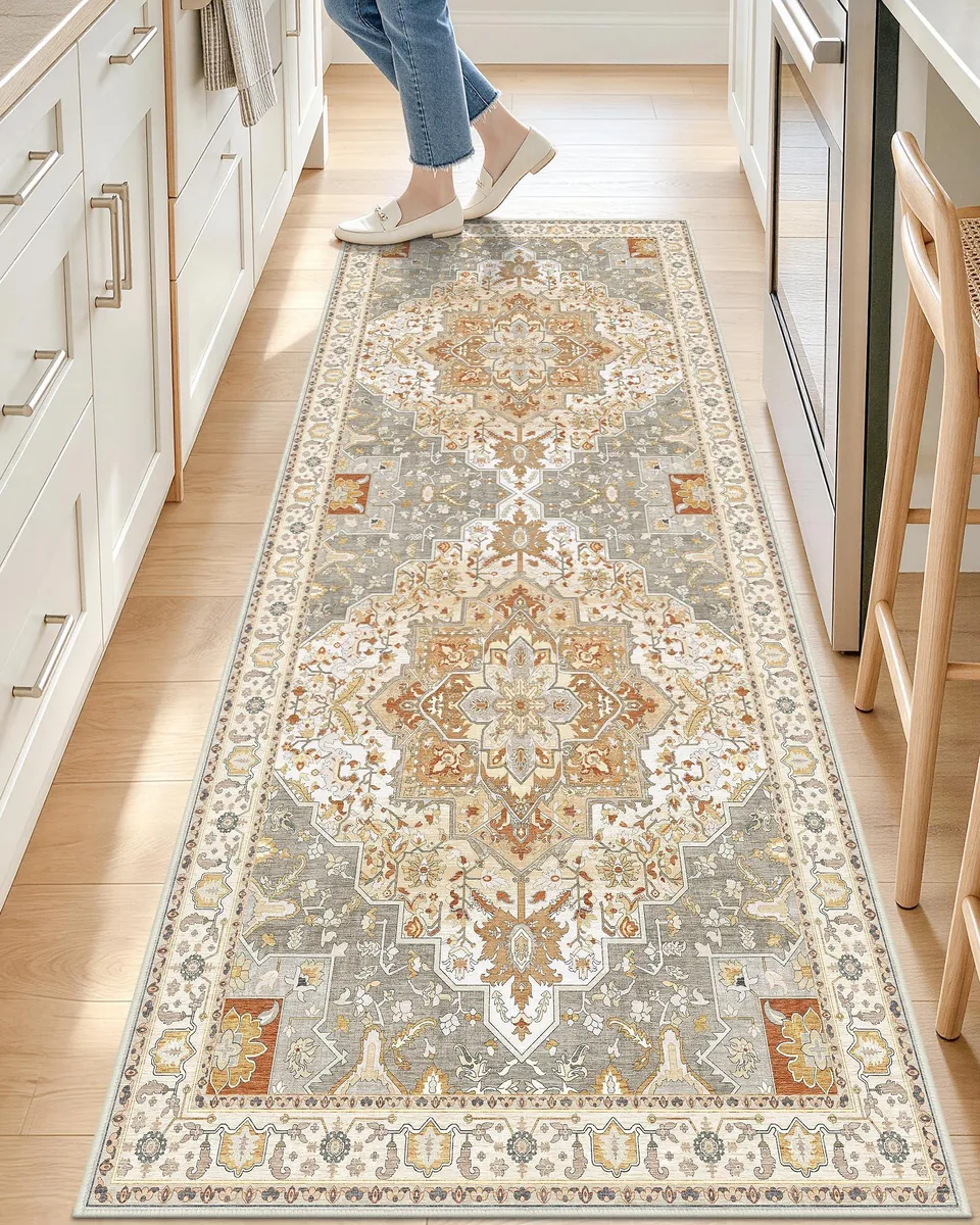 Beige polyester runner rug with distressed floral border, low pile, 2 by 6 feet