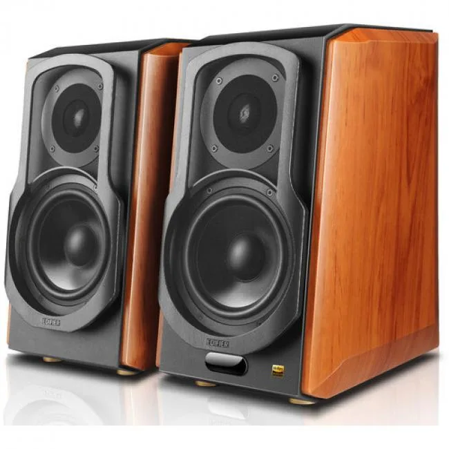 Pair of brown wooden bookshelf speakers with angled front panels and visible drivers