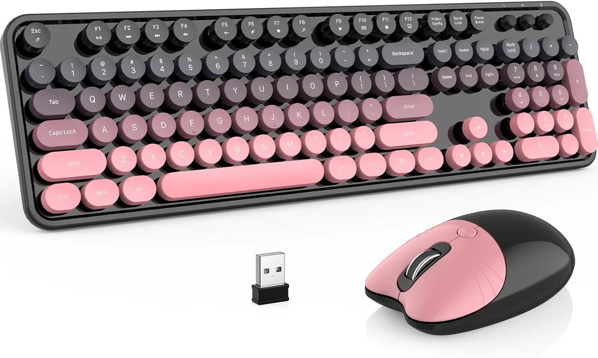 Pink gradient full-size wireless keyboard and matching mouse on desk