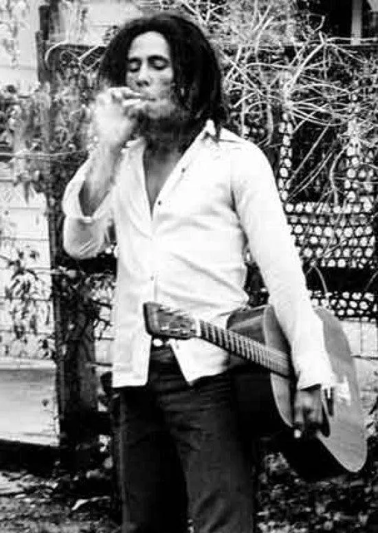Poster print of Bob Marley with spliff and guitar, 22 by 34 inches, rolled in tube