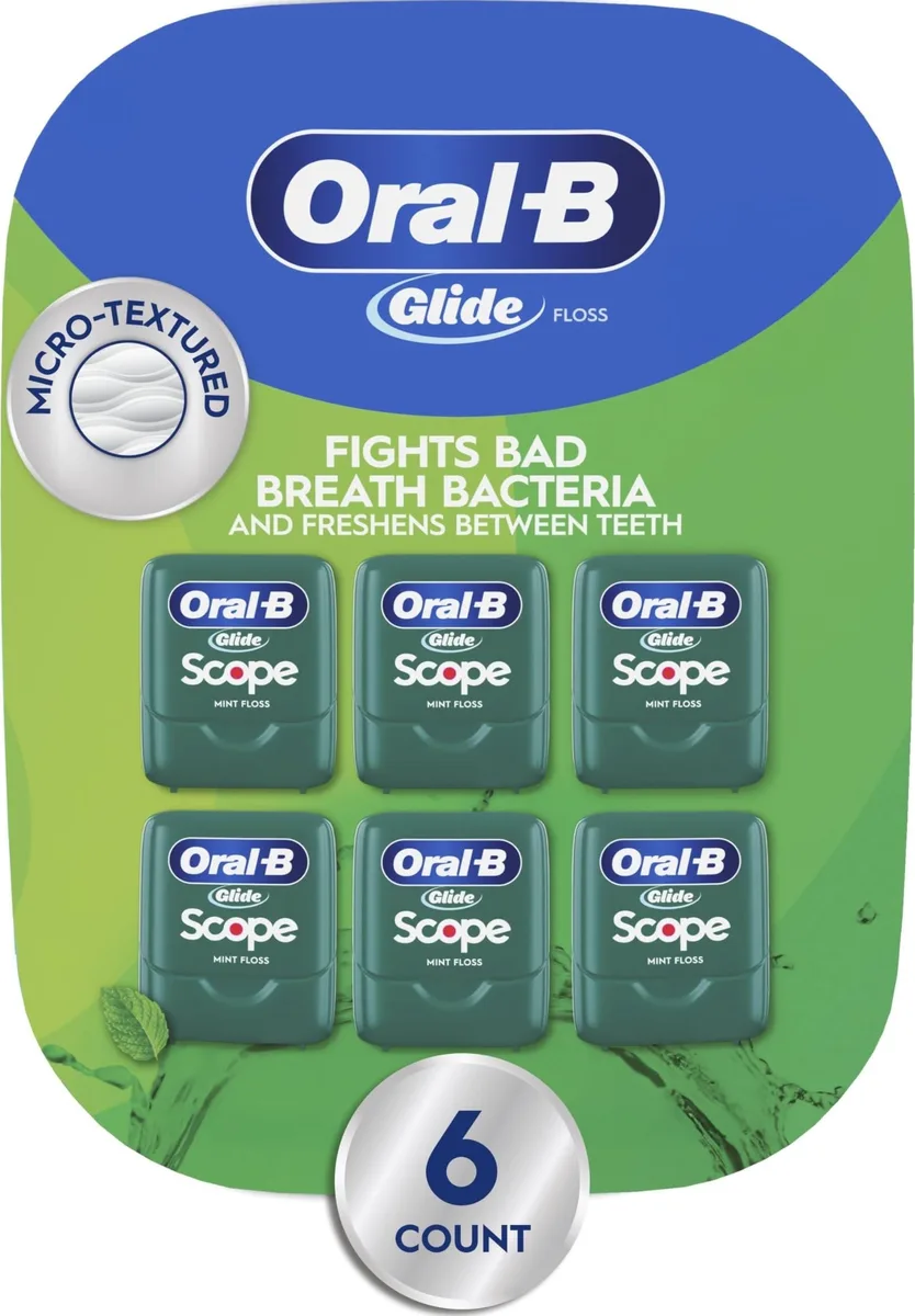 Six white plastic floss dispensers in a rectangular pack