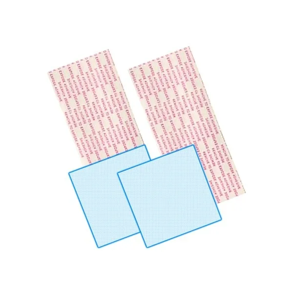 Two rectangular adhesive strips and a small wipe packet on a plain surface