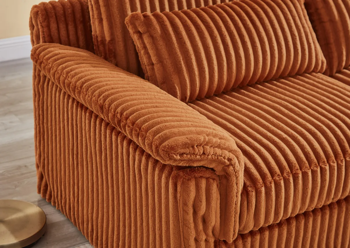 Orange corduroy two-seater loveseat with removable cushions, low profile, modern style