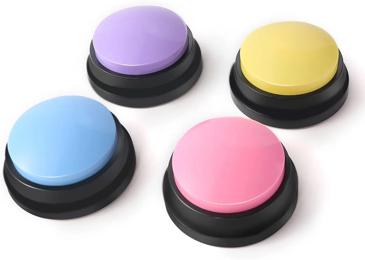Four round coloured buttons with REC labels on a flat surface