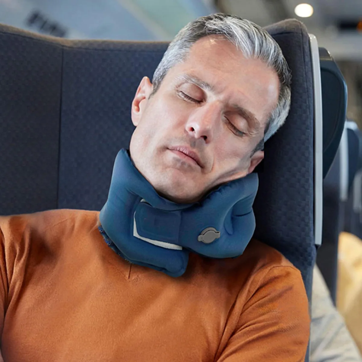 Small grey inflatable travel pillow, compact folded form, soft fabric finish