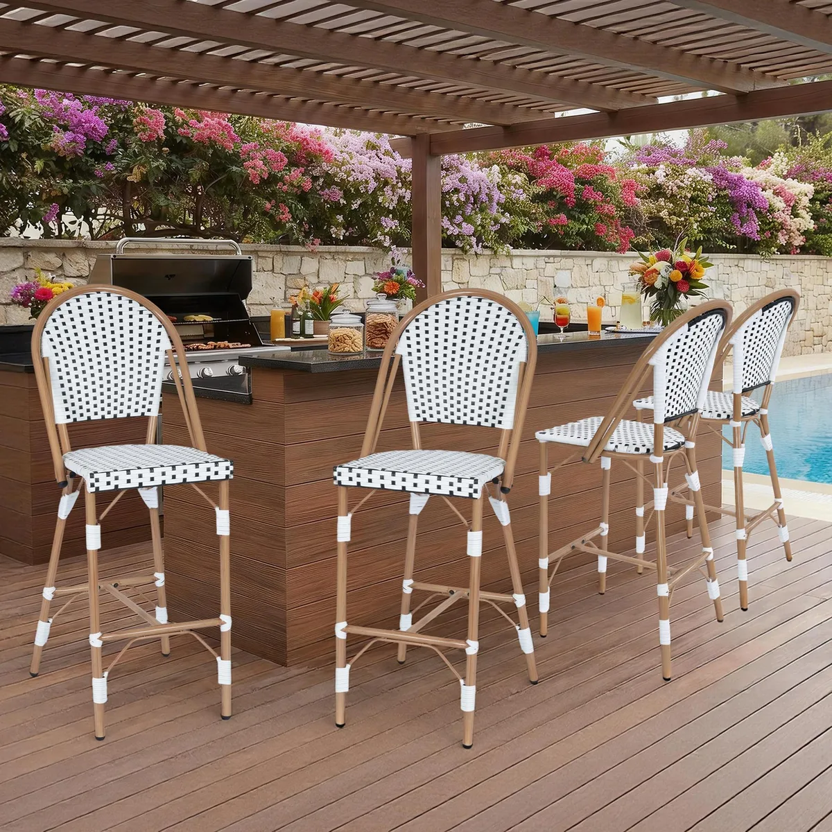 Four white rattan bar stools with black metal frames and built-in footrests