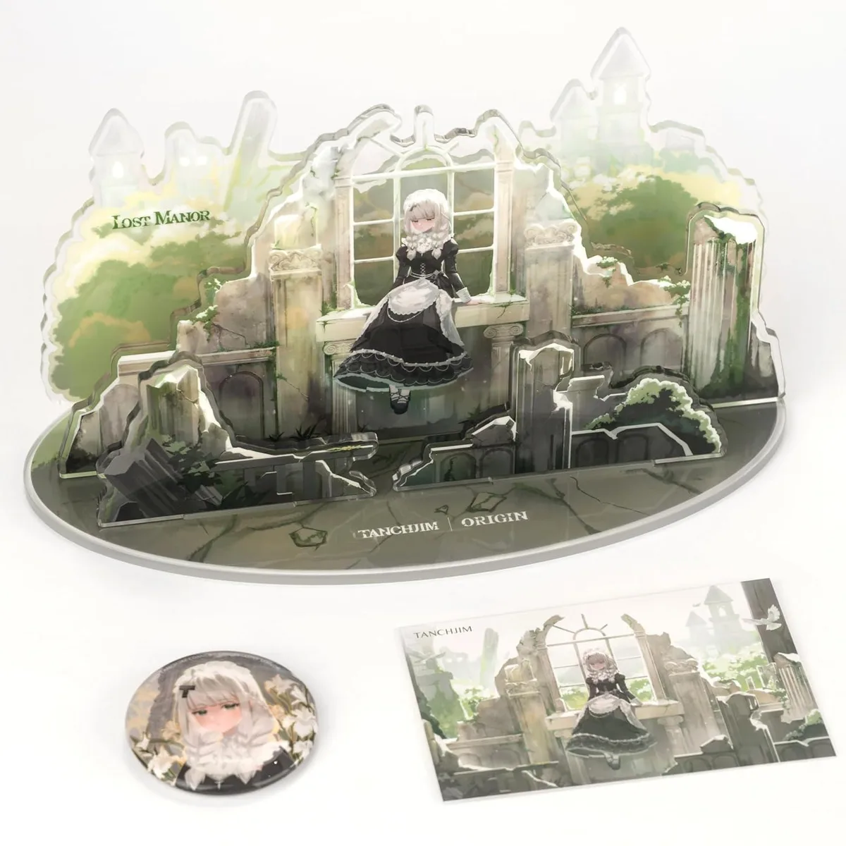 Gift box with standing figure, badge and postcard