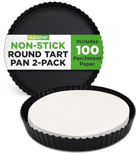 Two black round tart pans with removable bases and parchment papers