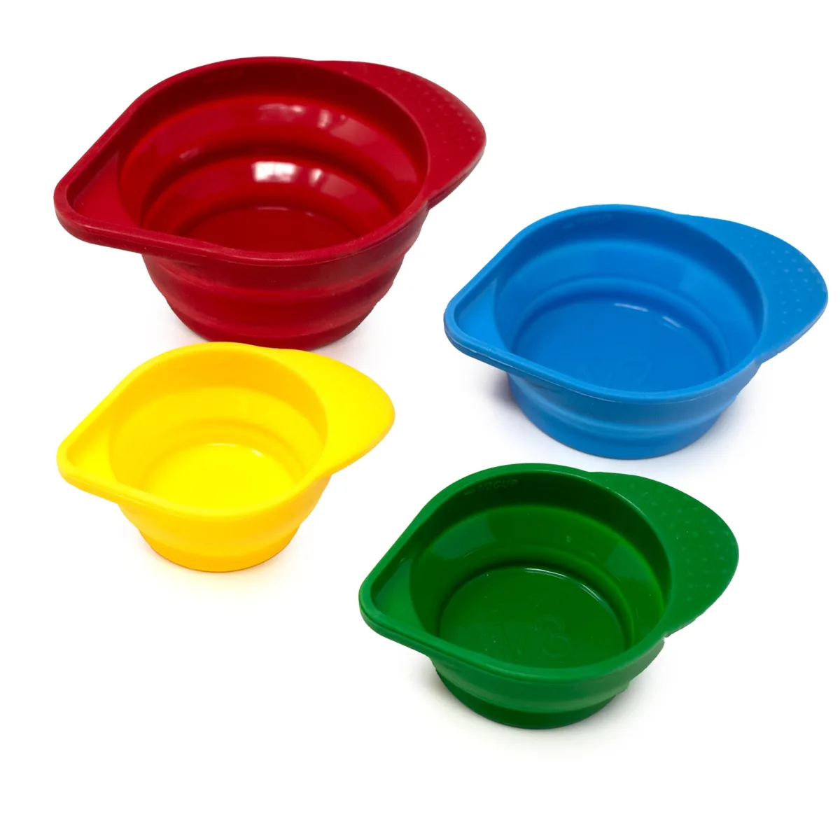 Four nested silicone measuring cups in graduated sizes, collapsed flat with textured handles visible