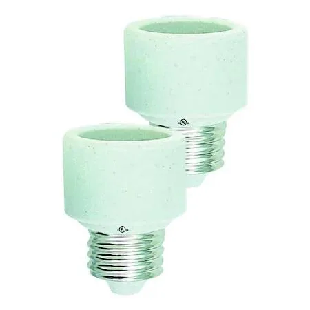 Two white porcelain socket extenders stacked together