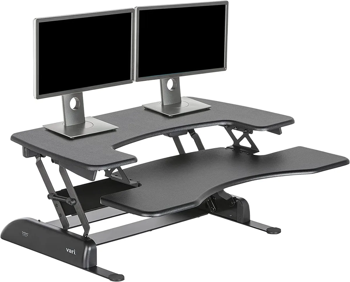 Black two-tier standing desk converter with dual handles and spring-assisted lift mechanism