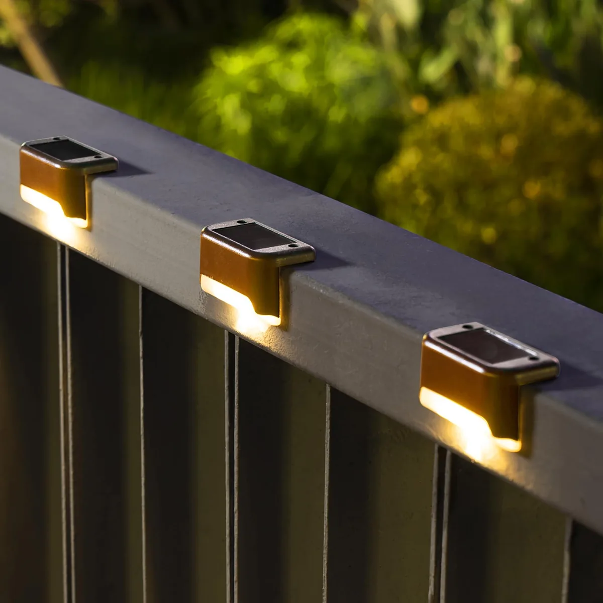 Twelve warm-white solar deck lights, polished chrome finish, rectangular ABS shells