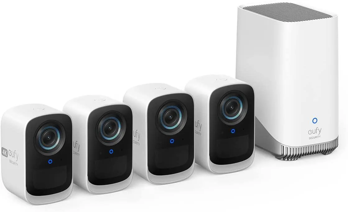 Four small white wireless cameras with spotlight lenses