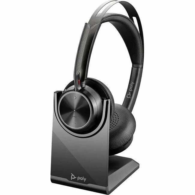 Black over-the-head stereo headset with cushioned headband, plush ear pads, flip-up microphone boom and charging stand