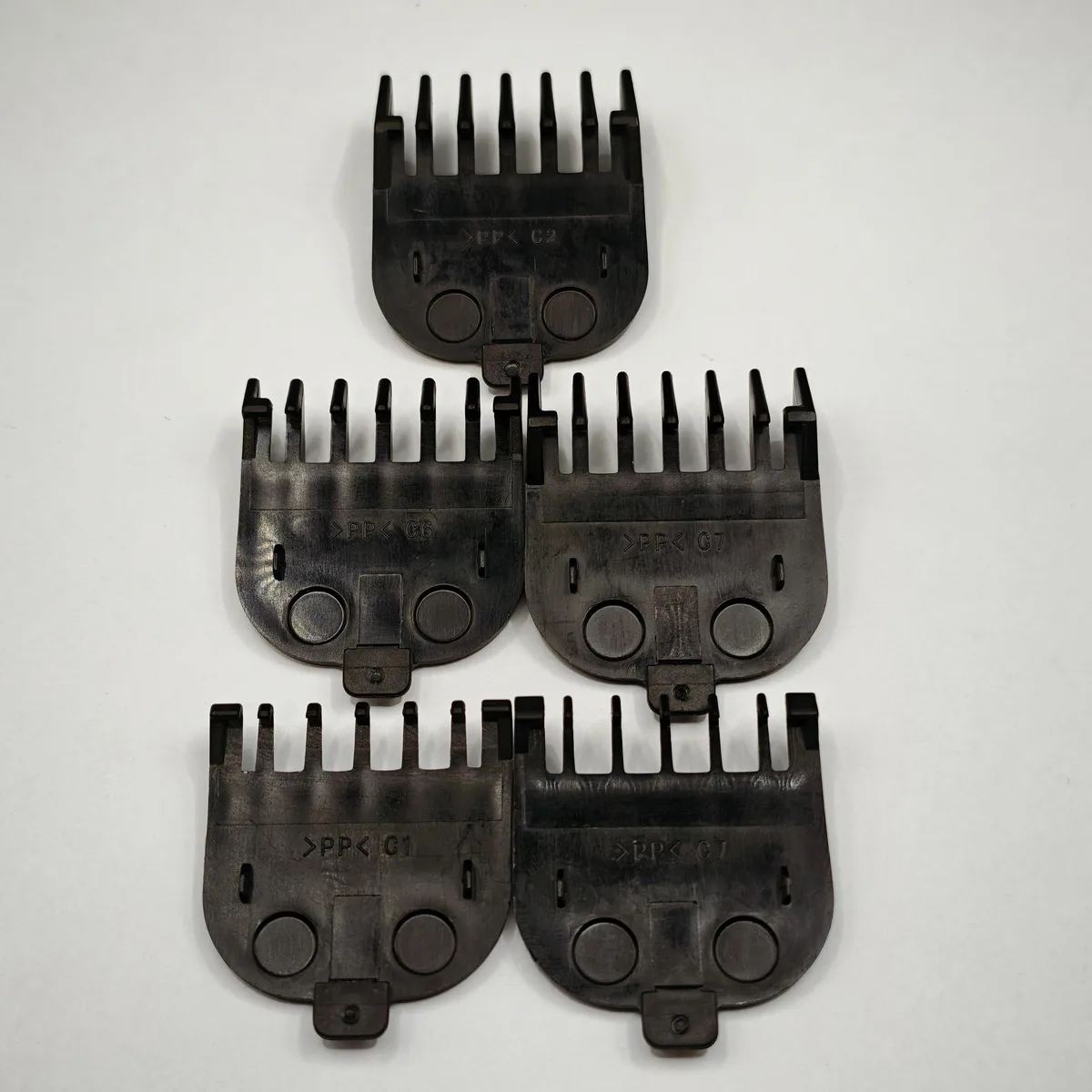 Five black guide combs in sizes 1.5mm to 12mm