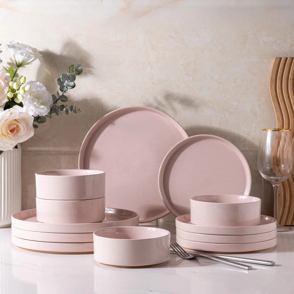 12-piece pink ceramic dinnerware set with speckled stoneware plates and bowls, unglazed terracotta base, square shape, glossy finish