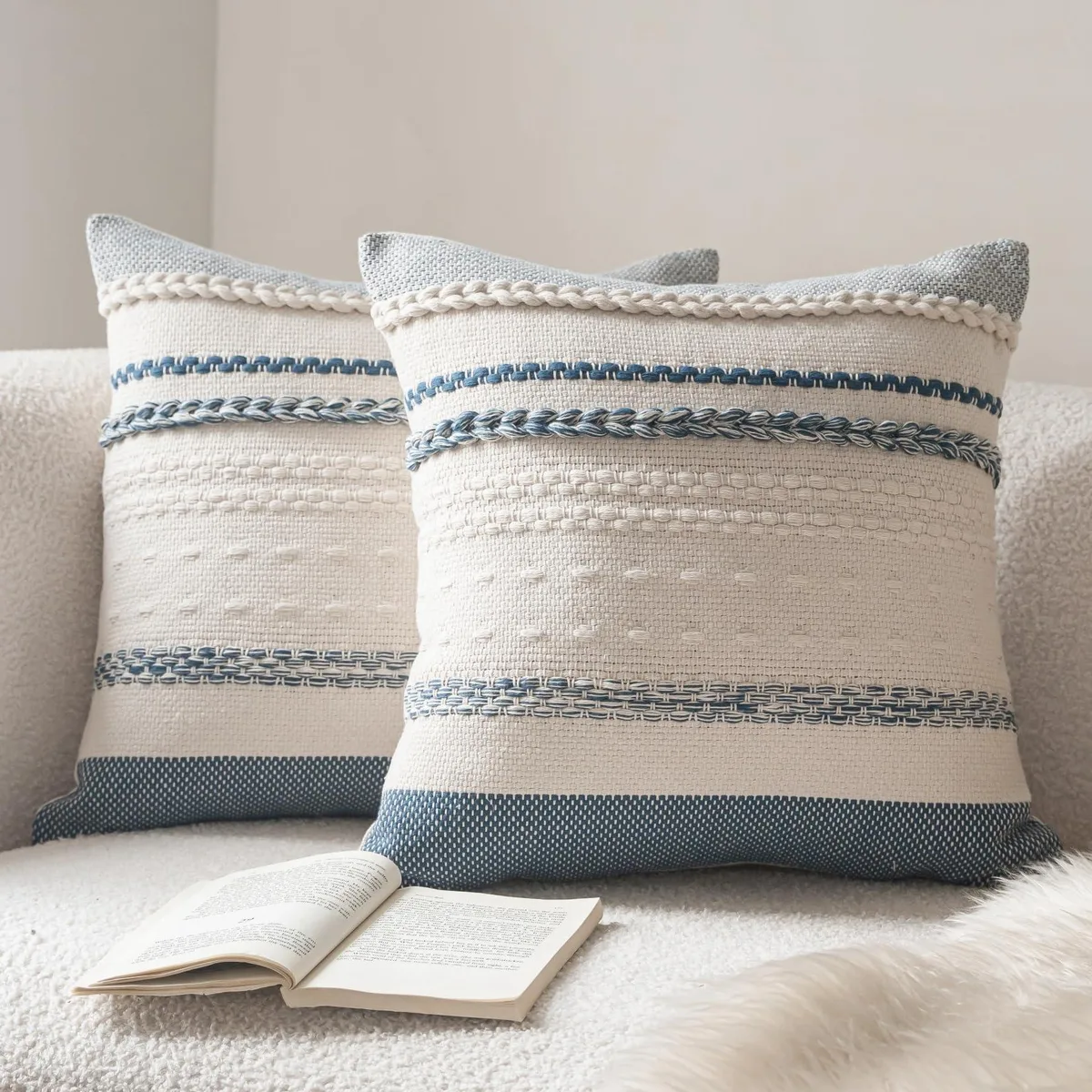 Two square blue cotton pillow covers with striped weave texture and hidden zipper closure