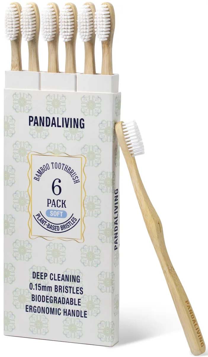 Six white bamboo toothbrushes with wave-shaped handles and medium plant-based bristles