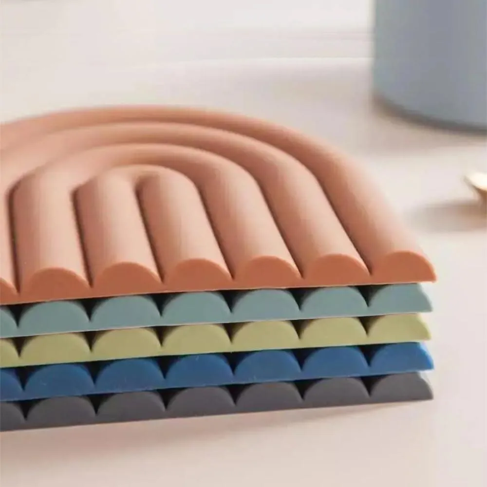 Five colourful 5.9in square silicone trivets, .39in thick, muted pastel tones