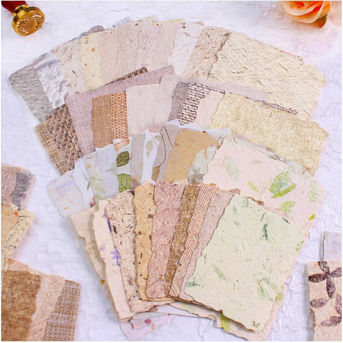 Stack of 84 textured embossed papers with deckled edges, botanical mulberry and fabric designs