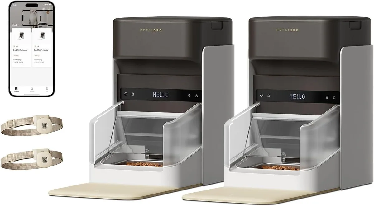 Two white automatic cat feeders with light collar tags
