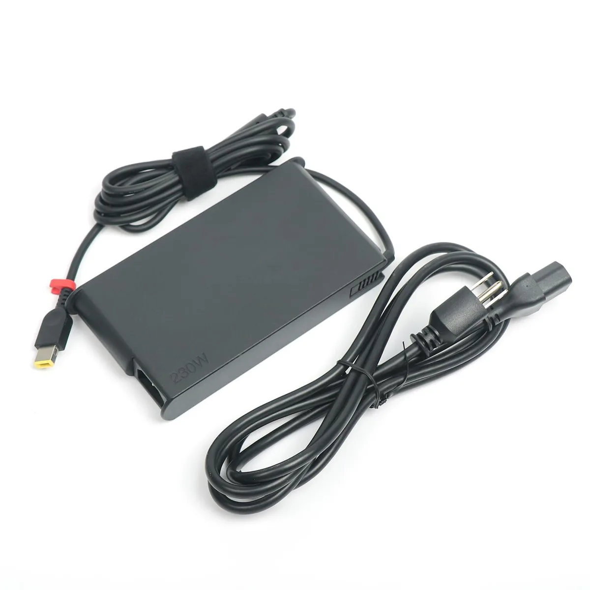 Black rectangular AC adapter with yellow slim tip connector and coiled cable
